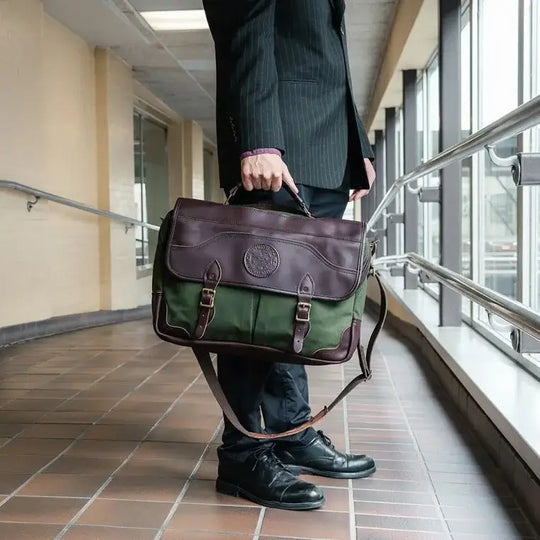 The Entrepreneur Briefcase In Olive Drab Green Being Held By A Man In A Skywalk
