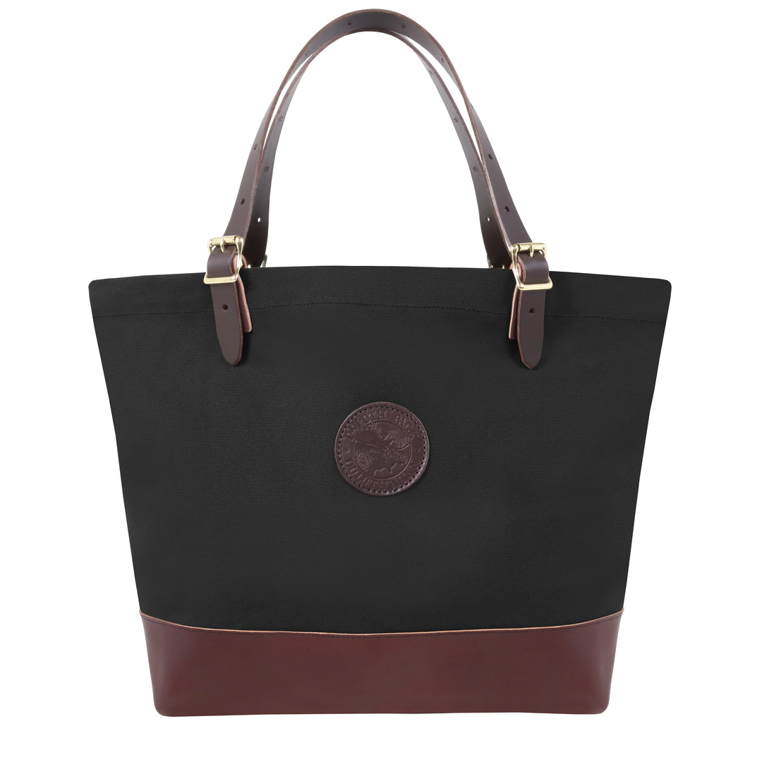 Deluxe Market Tote in black canvas with leather bottom and handles, featuring rugged construction and antique brass hardware for outdoor use and long-lasting durability.