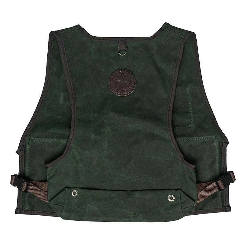 Fly Vest in dark green canvas with back-mounted d-ring and adjustable straps, designed by Duluth Pack for durable fly fishing gear use outdoors.
