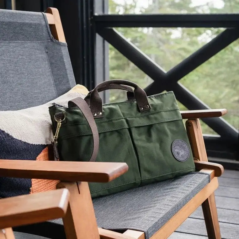 The City Briefcase In Olive Drab Green On A Chair In A Porch