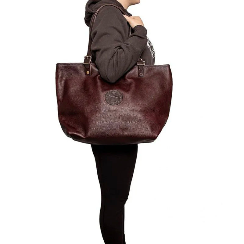Leather Market Tote in rich USA leather with adjustable premium leather handles, shown worn by a person dressed casually, highlighting durable craftsmanship for everyday use.