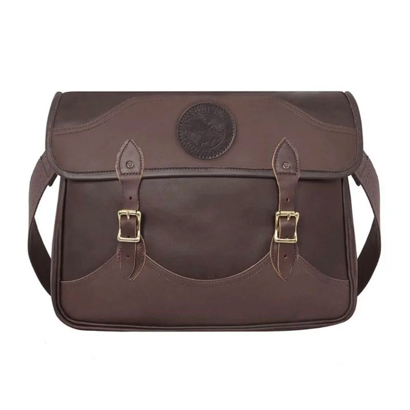 Leather Book Bag in rich brown premium leather with hand-cut construction and adjustable cotton web shoulder strap, designed for rugged, lasting use by Duluth Pack.