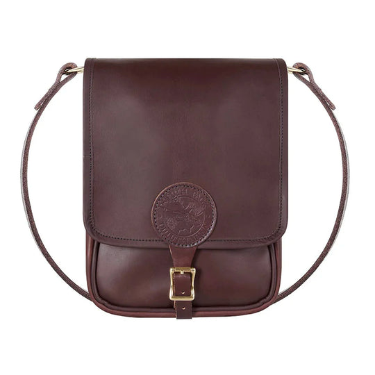 Leather Haversack in rich brown premium leather with buckling closure, handmade by Duluth Pack, designed for durable outdoor use and rugged adventure.