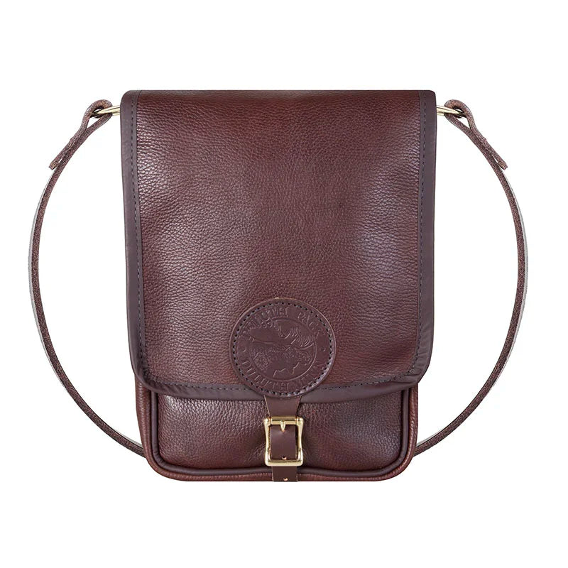 Leather Haversack in premium pebbled brown leather with brass buckle and strap, showcasing durable craftsmanship ideal for rugged outdoor use by Duluth Pack.