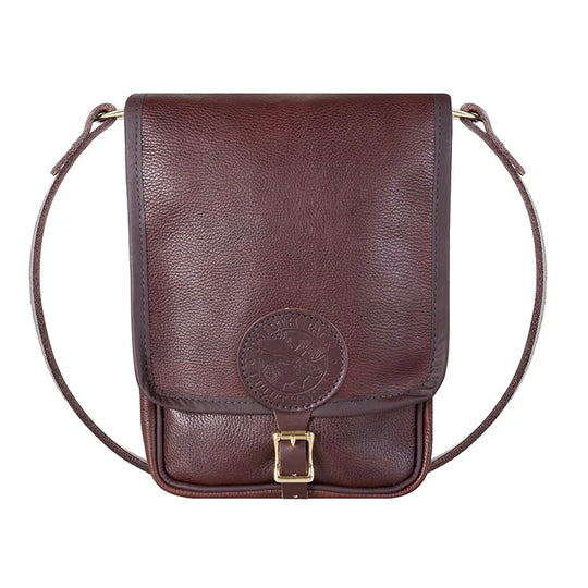 Leather Haversack in premium pebbled brown leather with brass buckle and strap, showcasing durable craftsmanship ideal for rugged outdoor use by Duluth Pack.