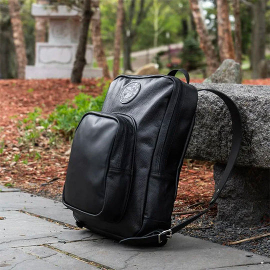 Leather Large Standard Backpack Leaning Against Stone Bench