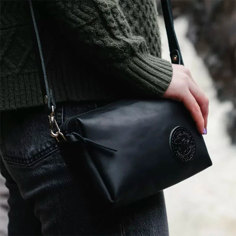 Leather Riverwalk Purse in Black With Hand with Waterfall in Background