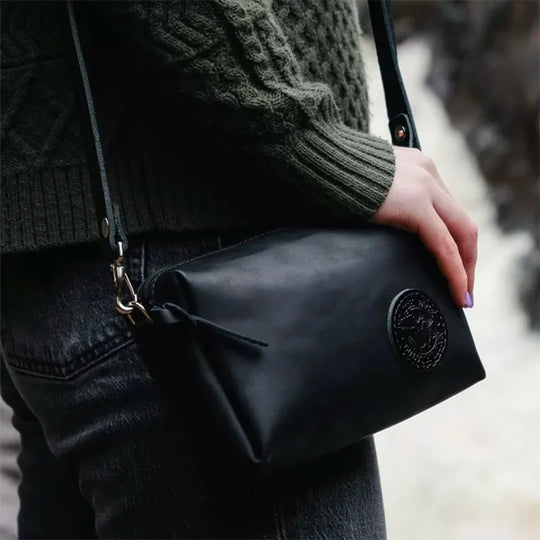 Leather Riverwalk Purse in Black With Hand with Waterfall in Background