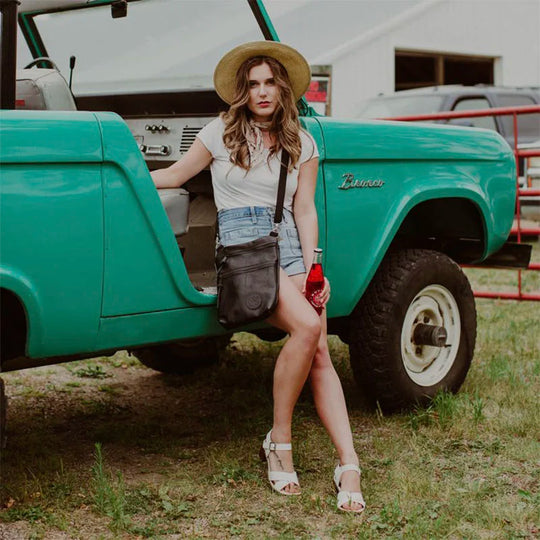 Leather Traverse Crossbody on Woman Leaning Against Classic Vehicle