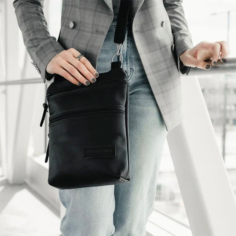 Superior Series Leather Traverse Crossbody on Woman With Hand on Bag