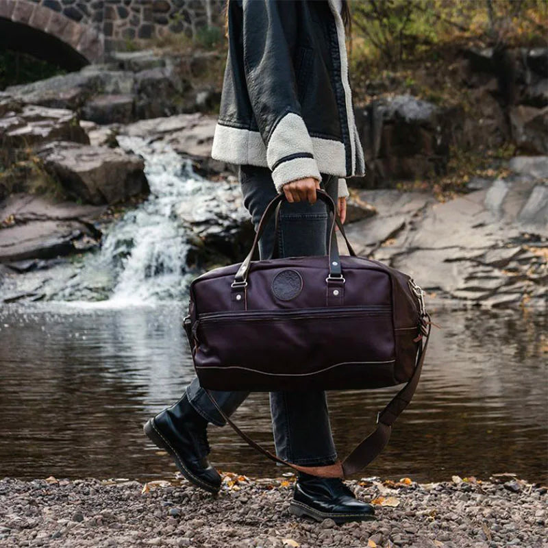 Leather Weekender Duffel held by Woman Walking by River