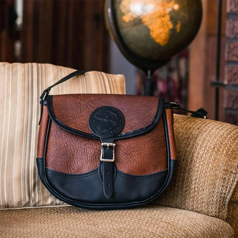 Bison Leather Medium Shell Purse on Couch with Globe in Background