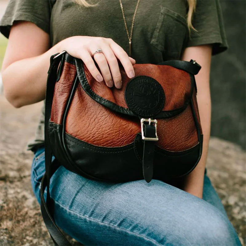Bison Leather Medium Shell Purse on Leg of Woman with Hand on Bag