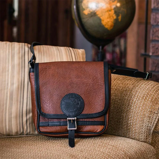 Bison Leather Mini Haversack on Couch with Globe in Background