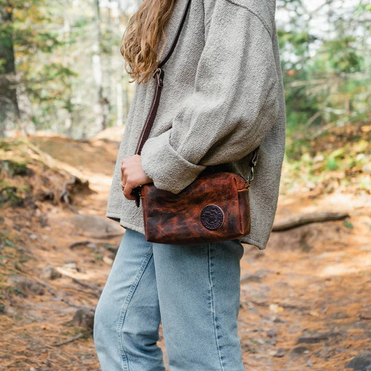 Heritage Leather Riverwalk Purse with a woman wearing with a forest in the background
