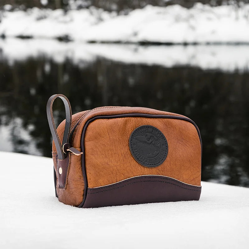 Duluth Pack Bison Leather Sportsman's Kit Bag brown trim with snowy background