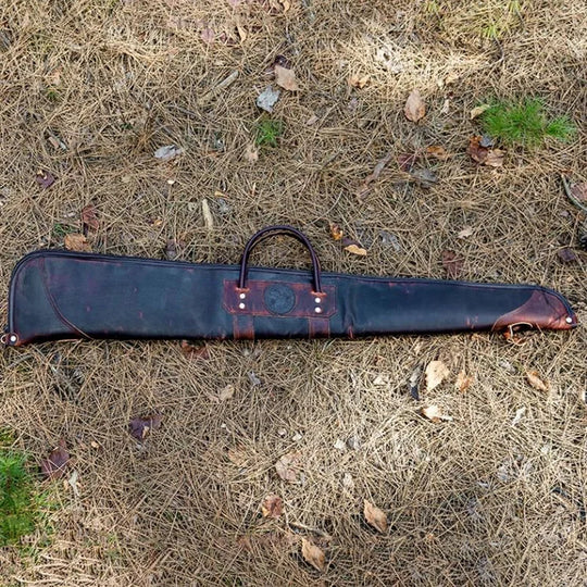 Heritage Leather Shotgun Case on the ground with pine needles in the background