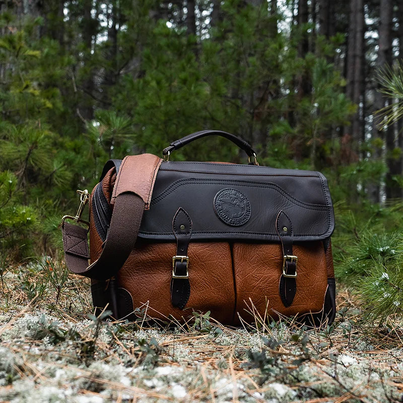 Duluth Pack Bison Leather Entrepreneur Briefcase with black trim with trees in the background