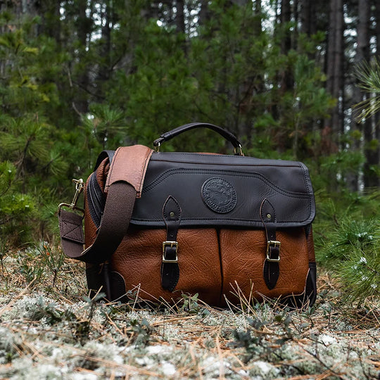 Duluth Pack Bison Leather Entrepreneur Briefcase with black trim with trees in the background