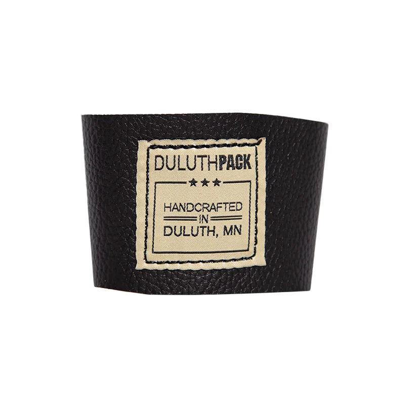 Leather Pint Glass Sleeve in black premium American leather with handcrafted Duluth Pack label, designed for durable outdoor use and comfortable grip.