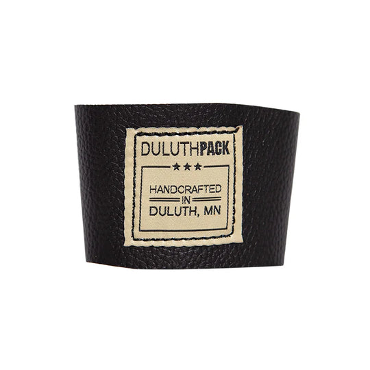 Leather Pint Glass Sleeve in black premium American leather with handcrafted Duluth Pack label, designed for durable outdoor use and comfortable grip.