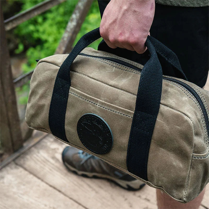 Lake Ontario Utility Bag Black Trim and Waxed Khaki Held by Man