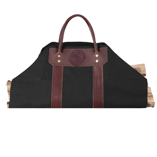Log Carrier in black canvas with riveted leather reinforcements, designed for carrying firewood at home, cabin, or camping sessions.
