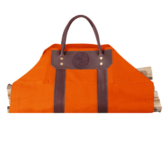 Log Carrier in vibrant orange canvas with riveted brown leather handles, designed for carrying firewood at home, cabin, or camping settings.