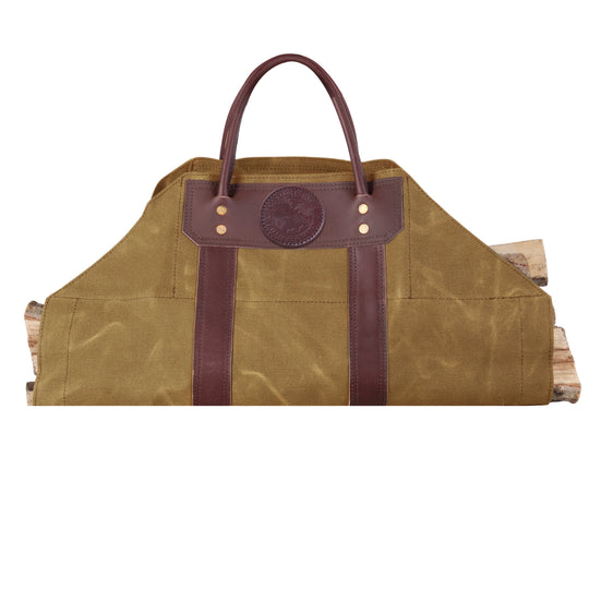 Log Carrier in rugged olive waxed canvas with riveted leather handles, designed for carrying firewood at home, cabin, or outdoor camping.