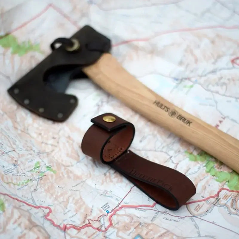 Duluth Pack Axe Holder Brown with an axe and map