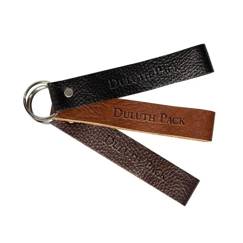 Duluth Pack Leather Keychain in bison, pebbled brown, and pebbled black leather with white background