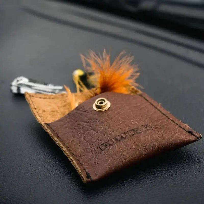 Duluth Pack Leather Hold-All Snap Wallet in Bison Leather with a black background.