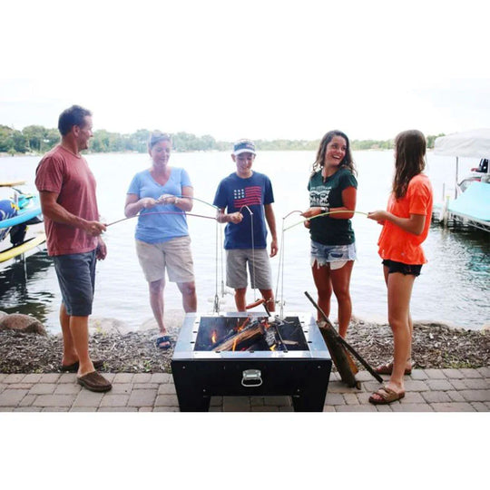 Family Holding Fishing Pole Roasters Over Fire
