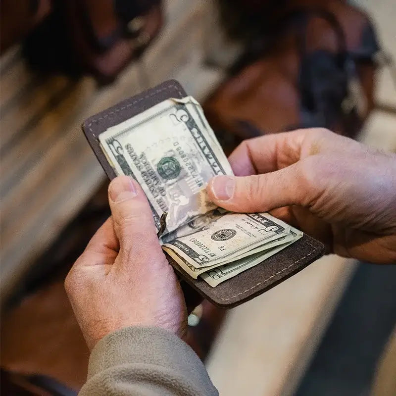 Duluth Pack Deluxe Money Clip Wallet in brown with person holding the wallet