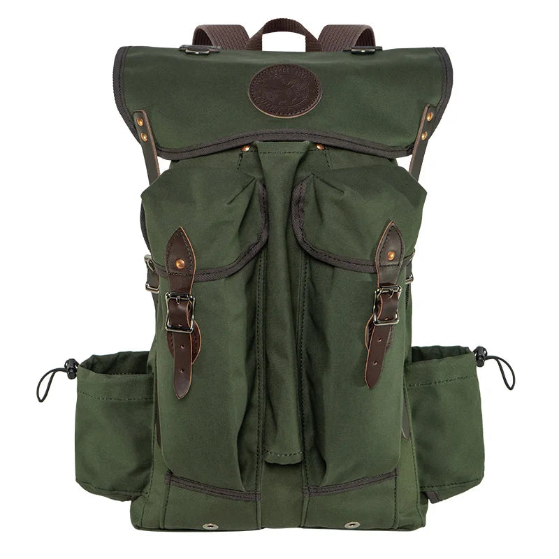 Outlander Pack in olive green canvas with leather straps, designed for rugged outdoor use and tight trail navigation by Duluth Pack.