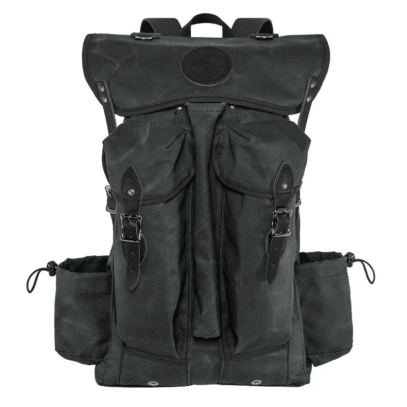 Outlander Pack in dark waxed canvas with leather accents, a handcrafted lightweight backpack designed for bushcraft and rugged outdoor use by Duluth Pack.