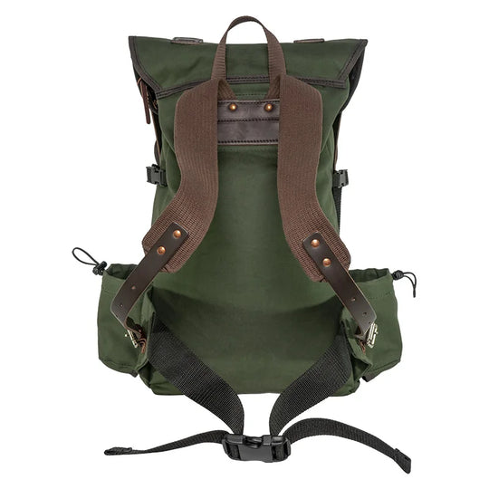 Outlander Pack in durable green canvas with leather accents by Duluth Pack, designed for rugged outdoor use on narrow trails and dense wilderness.