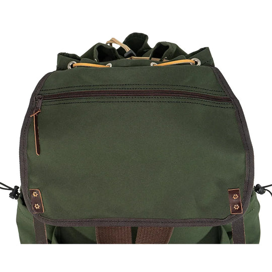 Outlander Pack in durable green canvas with leather accents, featuring a low profile design ideal for rugged outdoor use and tight wilderness trails.