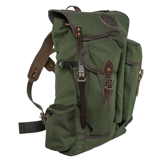 Outlander Pack in rugged green canvas with leather straps, featuring a low profile design ideal for dense wilderness trails by Duluth Pack.