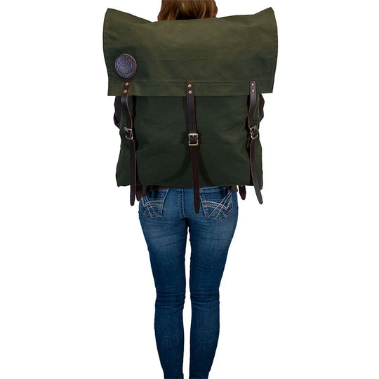 #2 Original Canoe Pack - 59 L in dark green canvas with reinforced leather straps, worn by a person standing, showcasing durable outdoor hiking gear by Duluth Pack.
