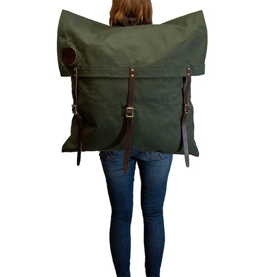 #3 Original Pack - 72 L in rugged green canvas with leather straps, worn by person showcasing durable outdoor gear by Duluth Pack for extended wilderness use.