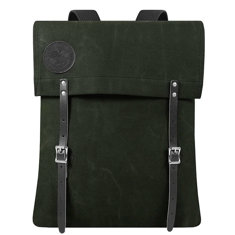 #51 Utility Pack in dark green waxed canvas with tough leather straps, designed for durable outdoor use by Duluth Pack, showcasing heritage craftsmanship.