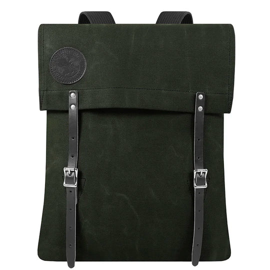 #51 Utility Pack in dark green waxed canvas with tough leather straps, designed for durable outdoor use by Duluth Pack, showcasing heritage craftsmanship.