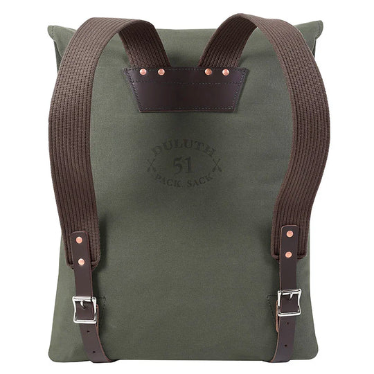 #51 Utility Pack in tough olive green canvas with brown leather accents and straps, designed by Duluth Pack for durable outdoor use and rugged performance.