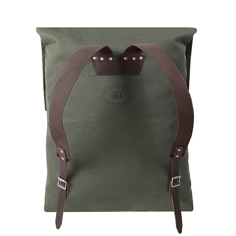 #60 Utility Pack - 42 L in waxed olive drab canvas with reinforced cotton shoulder straps and leather accents, designed for durable outdoor use by Duluth Pack.