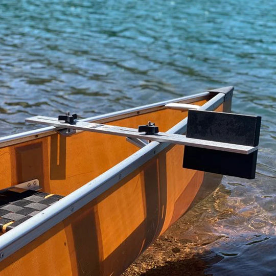 Spring Creek Tuff Motor Mount For Canoe on a canoe with a lake in the background