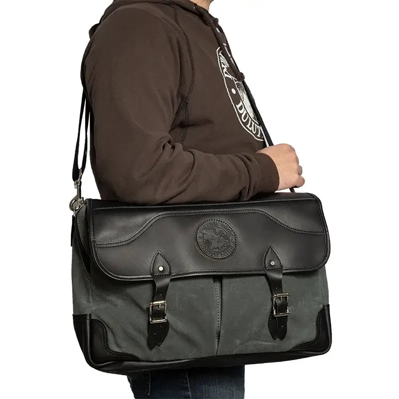 The Entrepreneur Briefcase In Waxed Grey Over The Shoulder Of A Man On A White Background