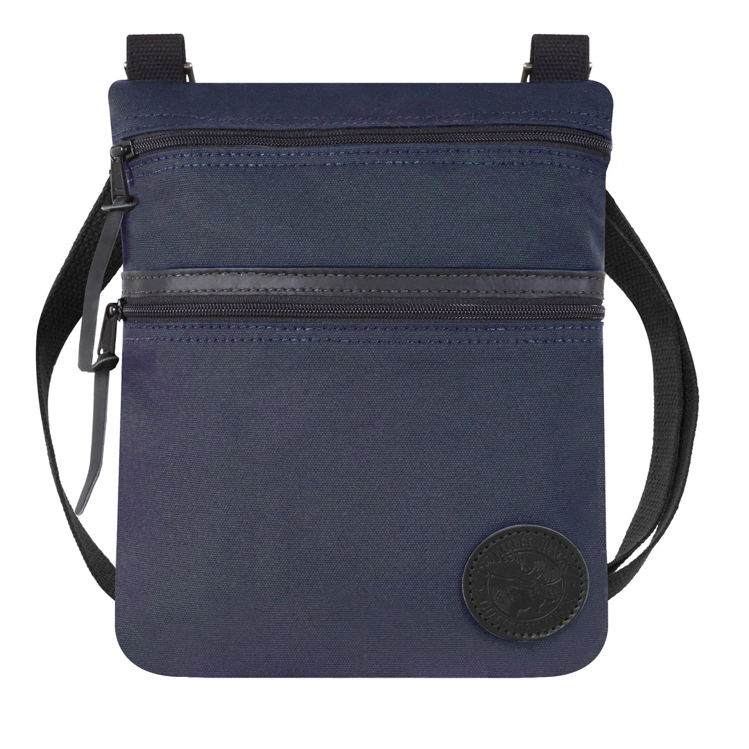 Traverse Crossbody Bag in navy with durable canvas and leather accents, featuring two zippered compartments and adjustable strap for versatile outdoor use.
