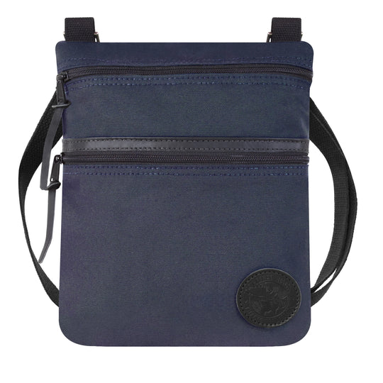 Traverse Crossbody Bag in navy with durable canvas and leather accents, featuring two zippered compartments and adjustable strap for versatile outdoor use.