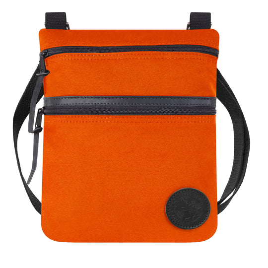 Traverse Crossbody Bag in vibrant orange with durable canvas and black adjustable strap, designed by Duluth Pack for versatile outdoor use.